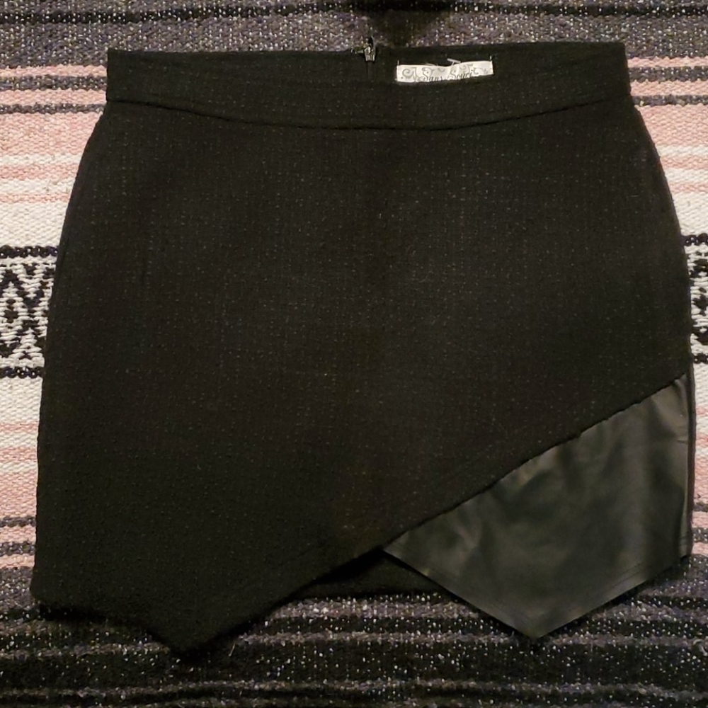 NWT cute black mini skirt with leather detail.